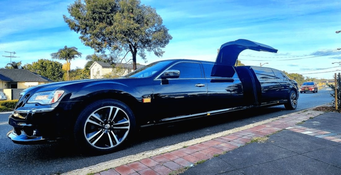 Black Chrysler Super Stretch — exterior, jet doors open, front three-quarter