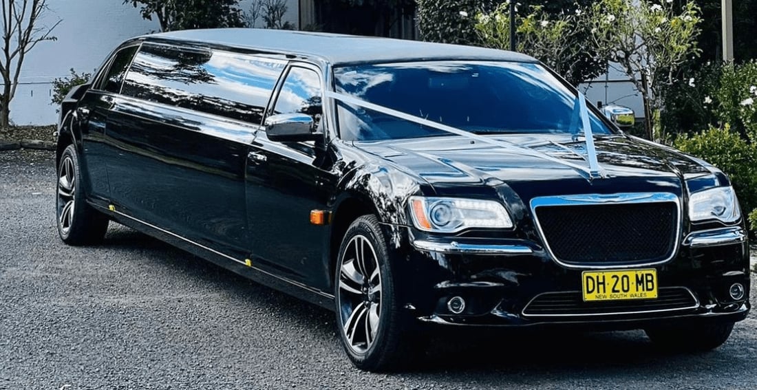 Black Chrysler Super Stretch — exterior, dressed with wedding ribbons