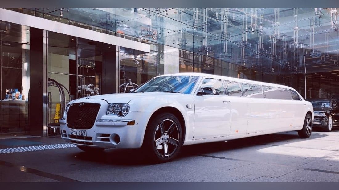 Chrysler Super Stretch (Black Edition) — exterior, at a glass-fronted venue