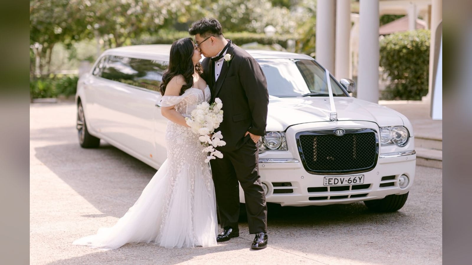 Chrysler Super Stretch (Black Edition) — a bride and groom beside the limousine
