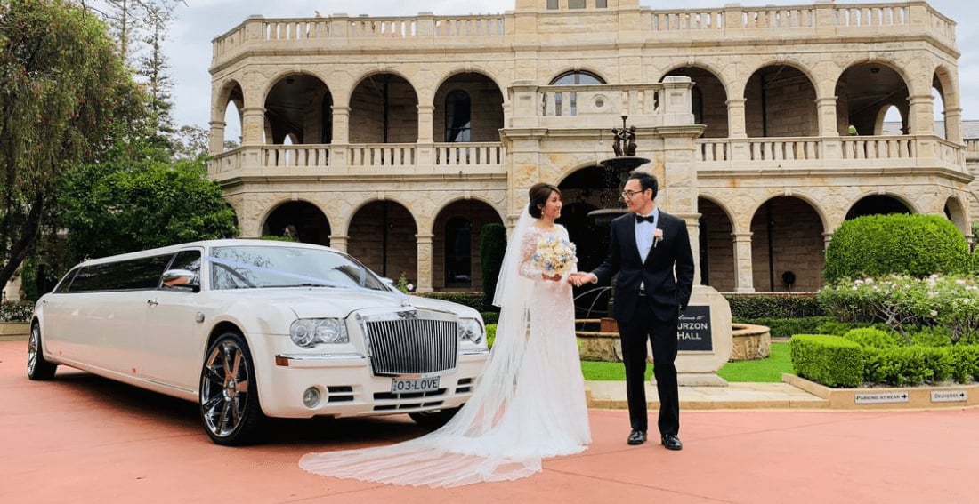 White Chrysler Super Stretch — exterior, at a grand reception hall