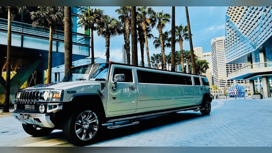 Stretch Hummer (14 Pax) — exterior, front three-quarter in the city