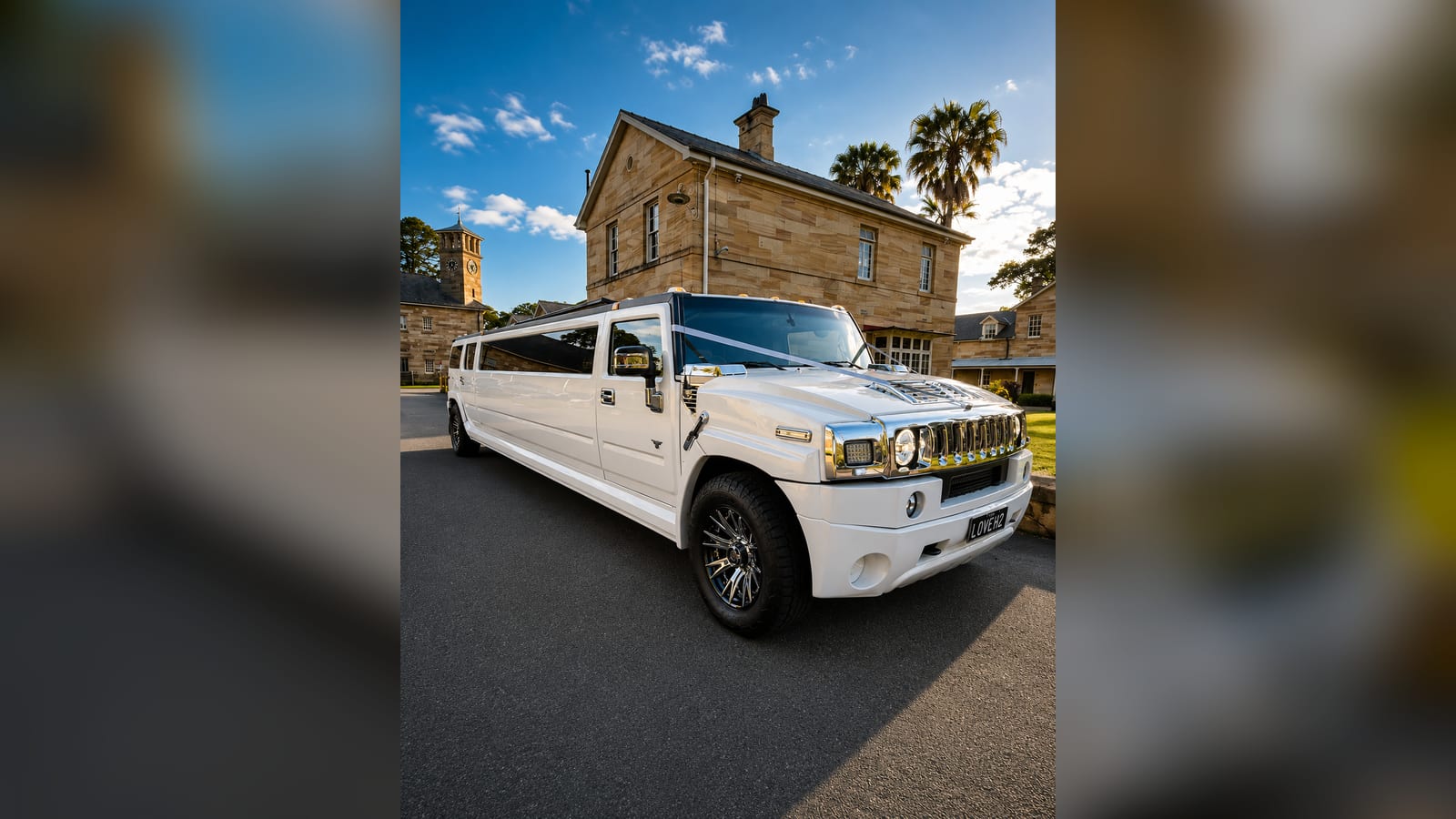 White stretch Hummer limousine, front three-quarter at a venue