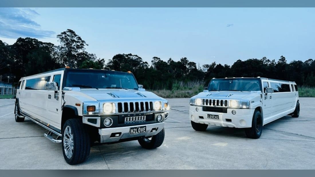 Two white stretch Hummer limousines side by side