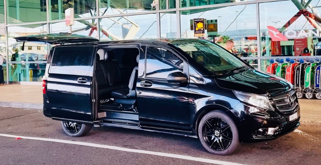 Mercedes Valente Luxury Minivan — exterior, side view, door open at the airport