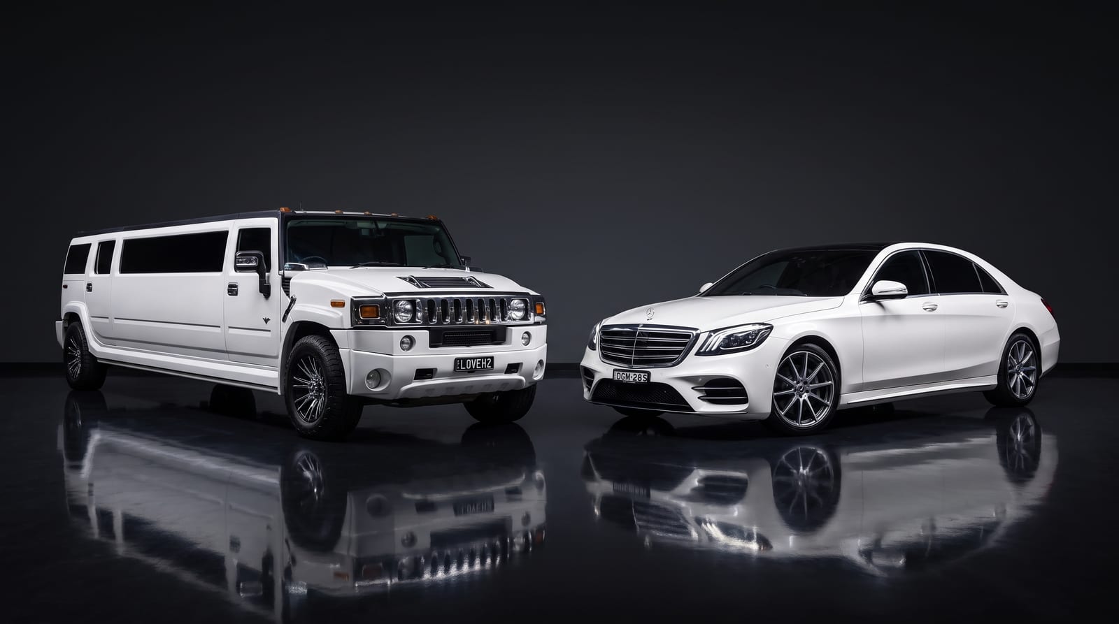 Platinum wedding package lineup — white Hummer stretch limousine and Mercedes S-Class in a dark studio